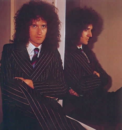 In a pin-stripe suit...