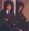 In a pin-stripe suit...