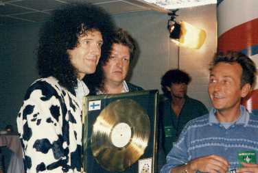 Brian with EMI people and gold Innuendo disc