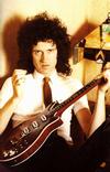 Brian sitting with guitar in the late 70's
