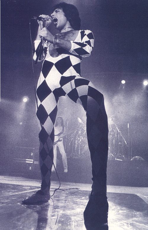 Freddie on stage in a black and white outfit