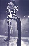 Freddie on stage in a black and white outfit