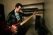 John deacon turing his bass guitar 