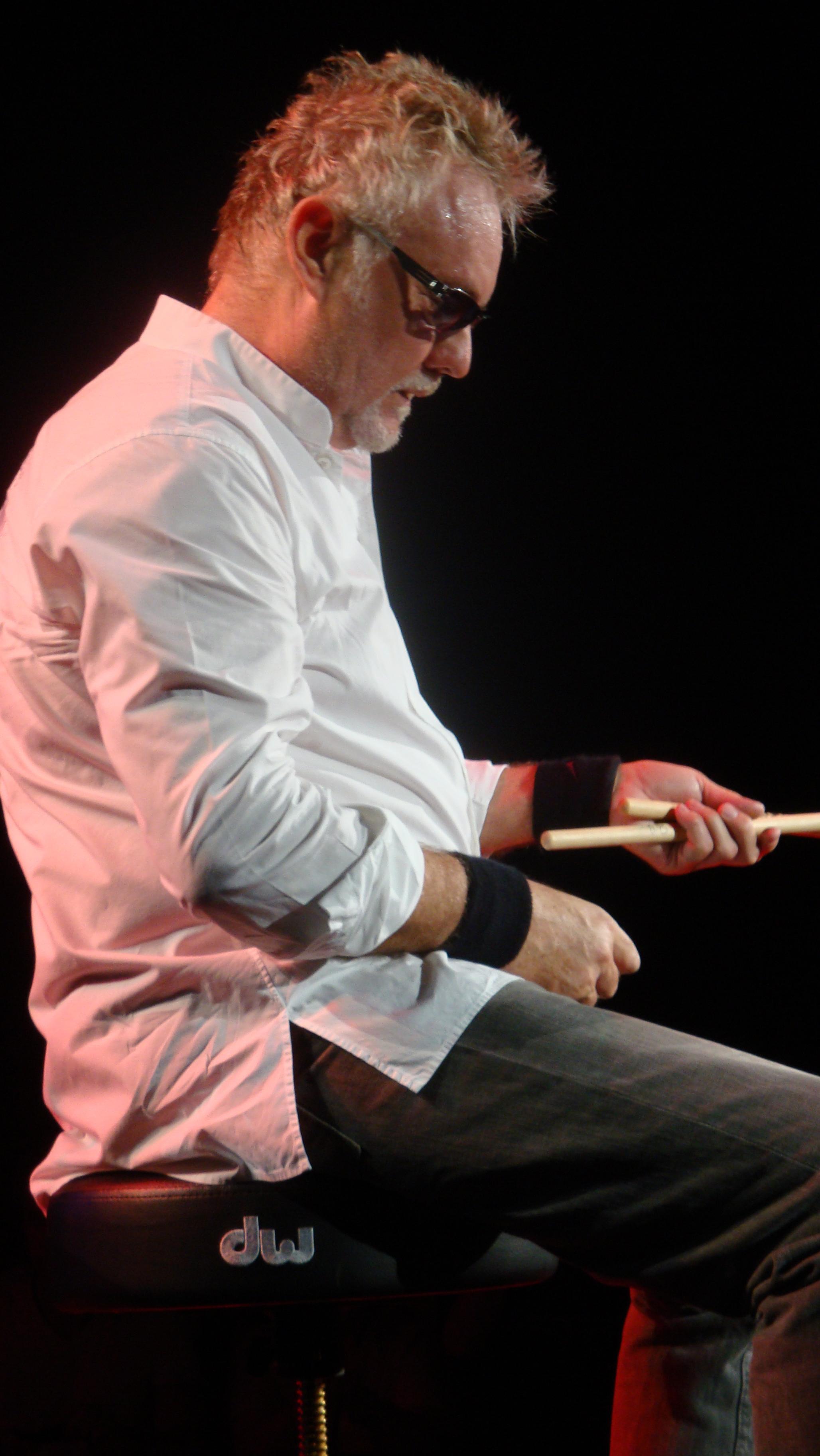 Roger Taylor in Luxembourg, looking drum sticks 