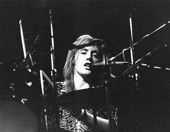 Rog singing on drums