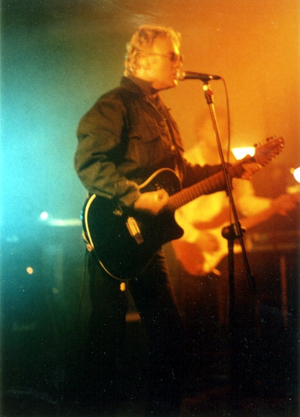 Roger playing acoustic guitar