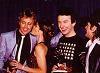 Roger gets a kiss, which seems to amuse John!